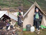 14 1 Yak Herders And Egg Lady, Jerome Ryan Drinking Tea At Pethang camp As I drank my milk-tea the next morning, I watched The Egg Lady start their fire with small branches and pieces of wood, and cooked in blackened pots balanced between rocks. She wore the typical Tibetan chuba, a black robe reaching from her shoulders to the top of her flimsy green Chinese sneakers, held together with a wide belt made of multi-coloured cloth on the back and silvery metal on the front, a long dark apron, and bright green long sleeved top. Her hair was braided and held in a bun with a coloured piece of cloth. The other six were still under their blankets beneath the tarp, all huddled close together sleeping head to head crossways.